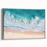 Framed canvas artwork showcasing a serene beach landscape, featuring soft pastel colors and a silver frame, ideal for coastal-themed home decor and relaxation.