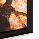 Close-up of textured black wall art featuring colorful, abstract fall motifs on a framed canvas, ideal for living room decor.