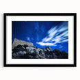 Black-framed landscape artwork showcasing dramatic cliffs with a mat border, perfect for enhancing home decor in modern or rustic settings.