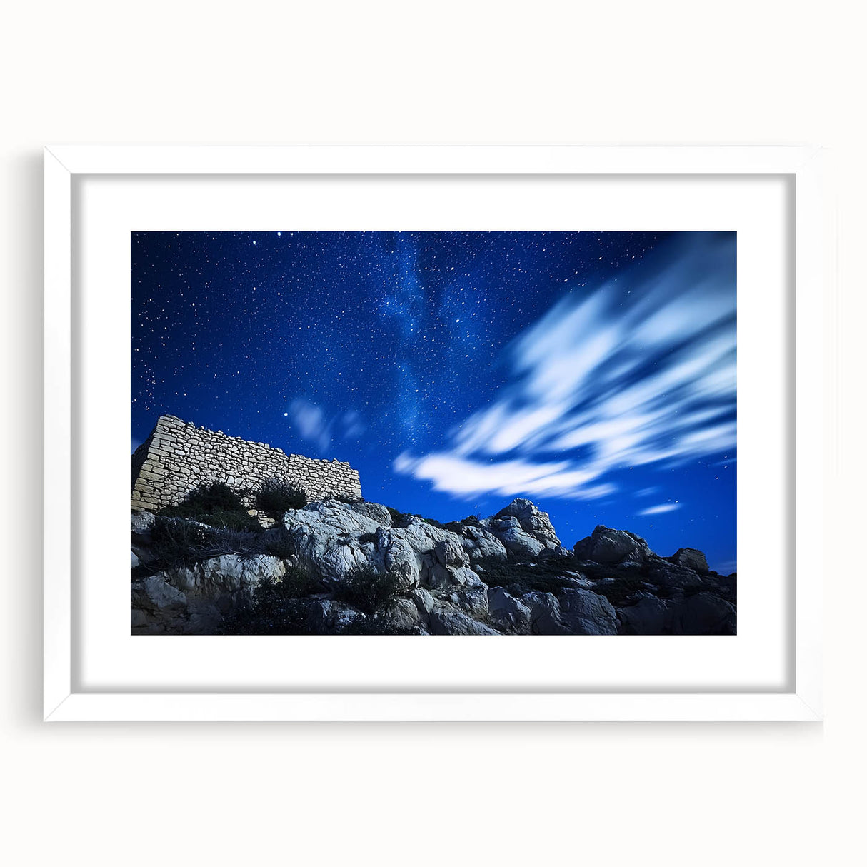 Framed landscape artwork showcasing dramatic cliffs against a serene sky, featuring a white mat and sleek frame, ideal for enhancing modern home decor.