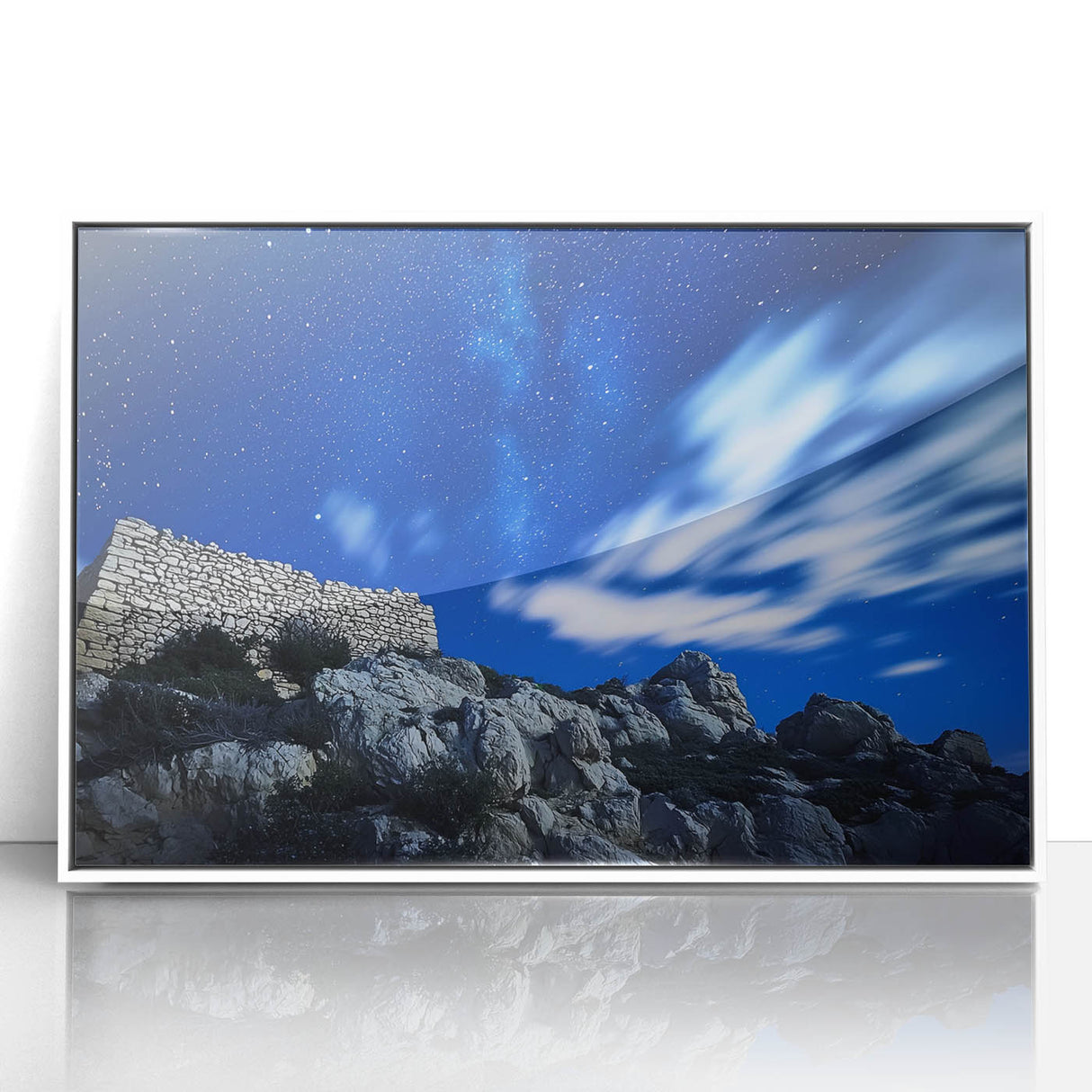 Framed acrylic artwork showcasing a dramatic landscape of rugged cliffs against a vibrant sunset, highlighted by a sleek white frame, perfect for home decor.