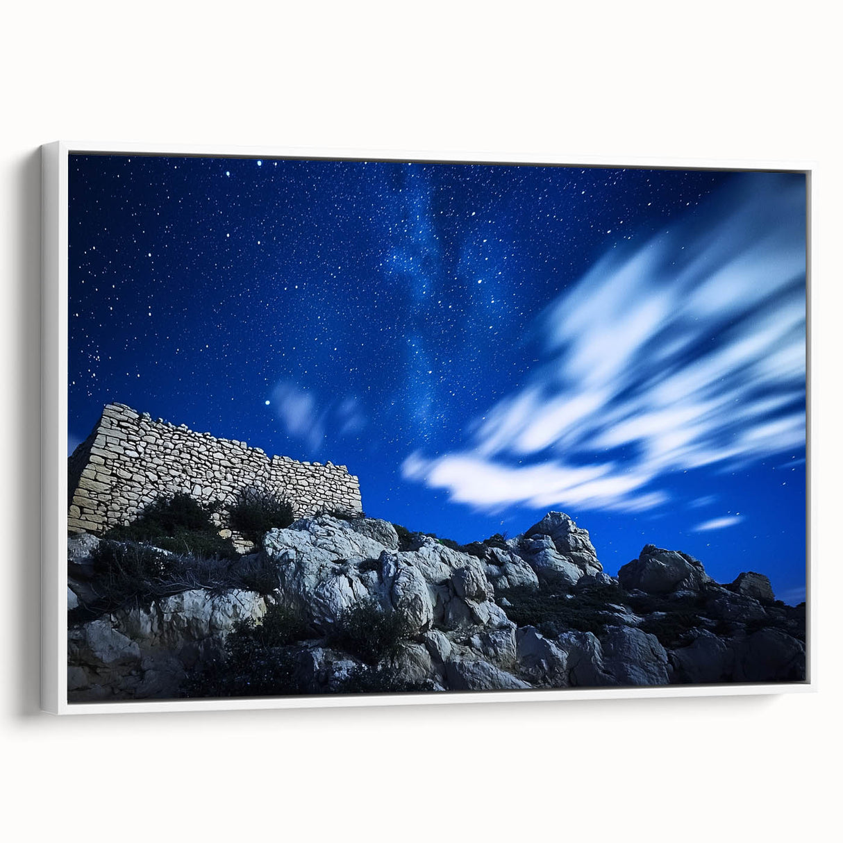 Framed canvas artwork showcasing a majestic landscape of cliffs, highlighted by vibrant colors and intricate details, presented with a sleek white frame for a modern touch. Perfect for enhancing home decor with natural beauty.