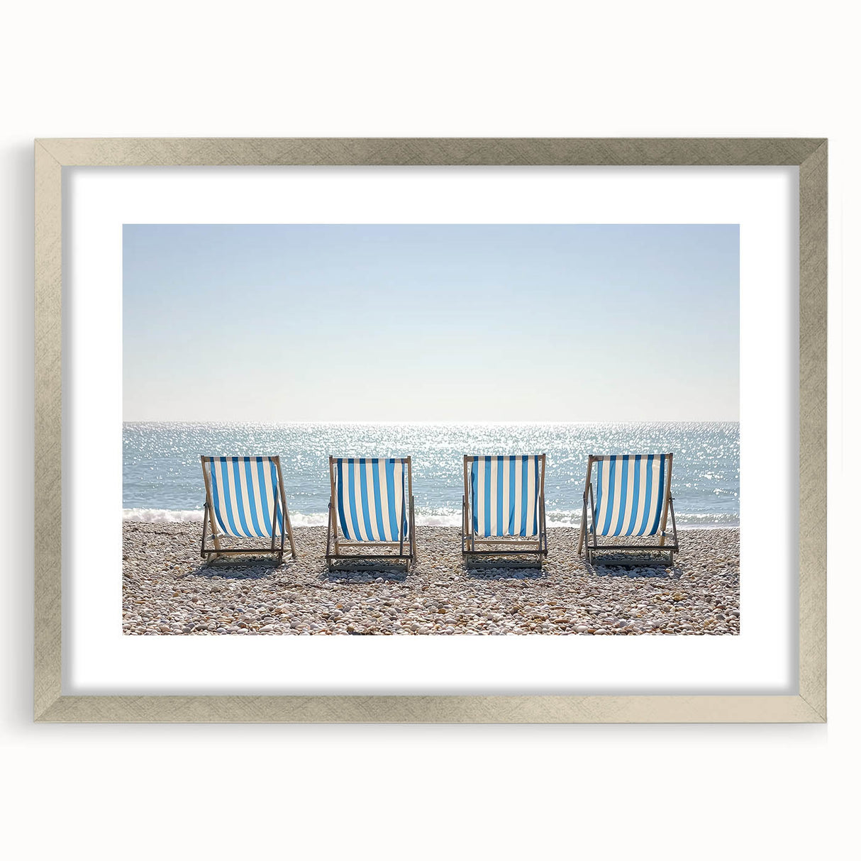 Silver-framed landscape art print showcasing a serene beach scene, complete with a white mat, ideal for coastal-themed home decor or beach house interiors.