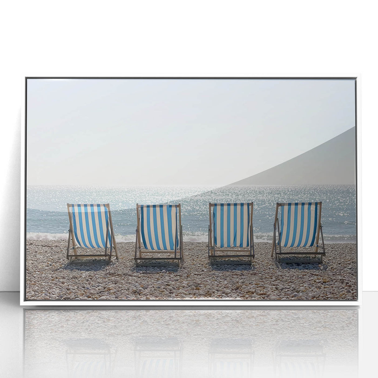 Framed acrylic artwork showcasing a vibrant beach landscape with soft waves and a clear blue sky, mounted in a sleek white frame, perfect for coastal decor.