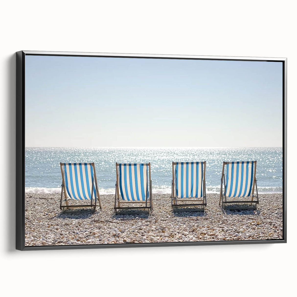 Framed canvas artwork depicting a serene beach landscape, featuring vibrant colors and detailed textures, showcased in a sleek black frame from a side view. Ideal for enhancing coastal-themed decor.
