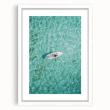 Abstract art print featuring swirling blue and green patterns on a white framed canvas.