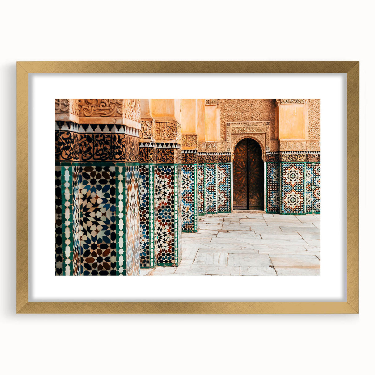 Textured abstract art print of a Moroccan landscape in earth tones, framed in gold, suitable for bedroom decor.