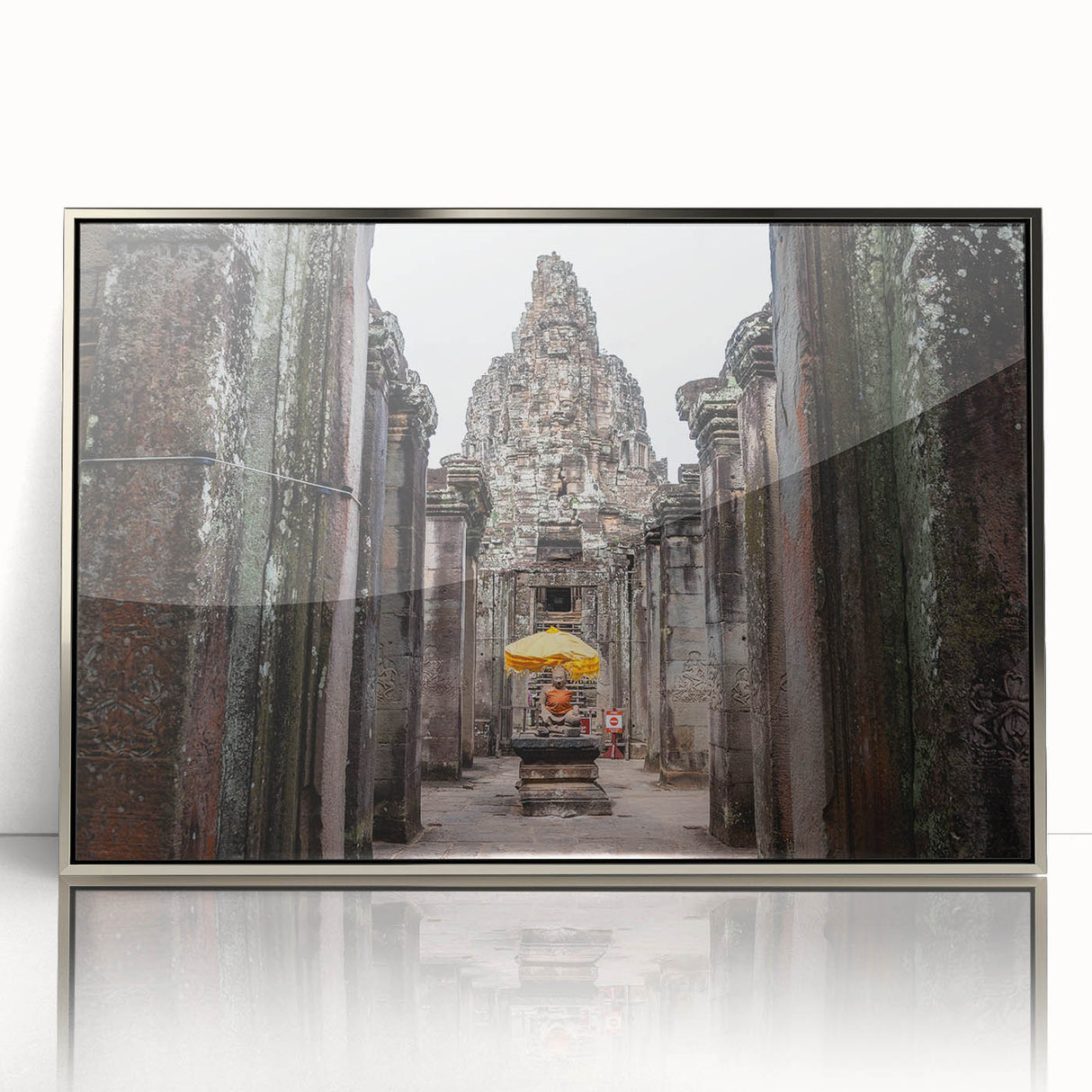 Mid-century modernist art depicting a Cambodian landscape in muted earth tones on a silver-framed acrylic print.