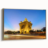 Framed canvas featuring a vintage-style landscape painting of a Laotian scenery in muted gold and black tones.