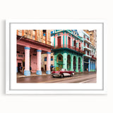 Textured art print featuring abstract Caribbean scenery in vibrant blue and green hues, framed with a white mat.