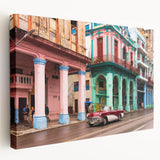 Large art print of a Caribbean beach scene in vibrant blue and green tones on stretched canvas.