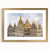 Abstract art print of a European scenery in muted gold and green tones, framed with a gold mat.