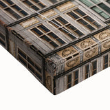 Large art featuring a black and white landscape painting of a European scenery on stretched canvas.