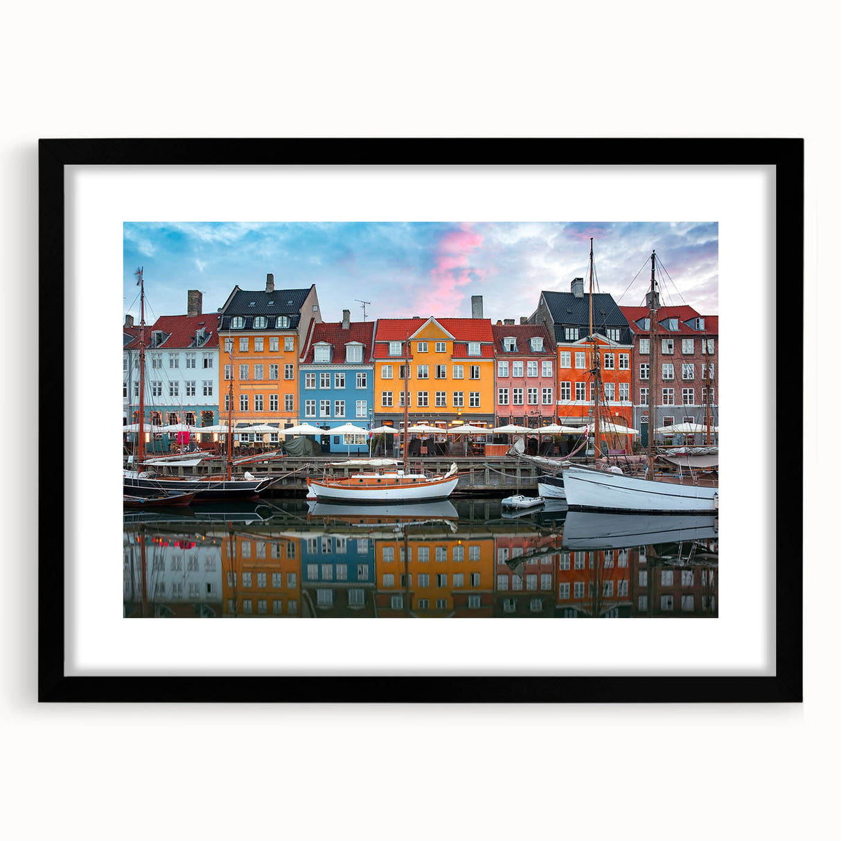 Abstract art print of a colorful, textured European scenery on a large black-framed canvas, suitable for living room decor.