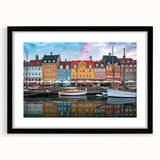 Abstract art print of a colorful, textured European scenery on a large black-framed canvas, suitable for living room decor.