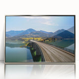 Large art print of a Bavarian landscape in muted green and blue tones, framed in silver acrylic.