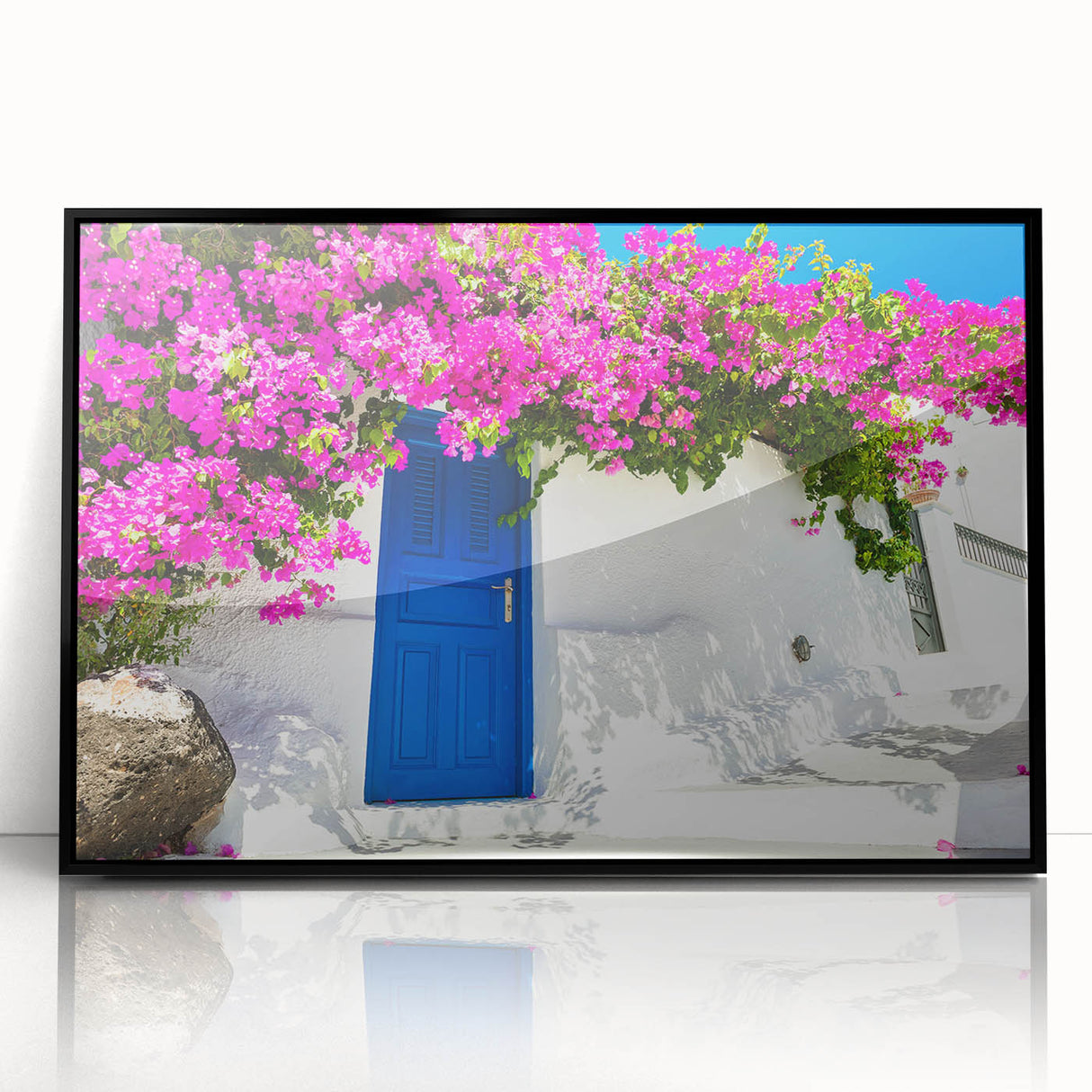 Large abstract wall art of Santorini with blue and white tones on acrylic, framed in black.