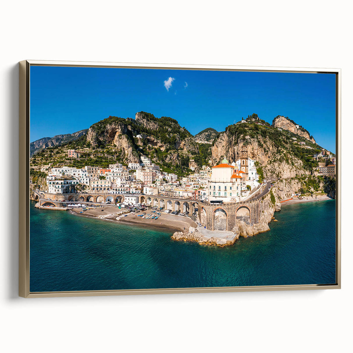 Framed canvas depicting the Amalfi Coast with vintage poster art style in muted gold and black tones.