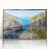 Large art print of Capri coastline in muted blue and white tones, framed in silver acrylic.