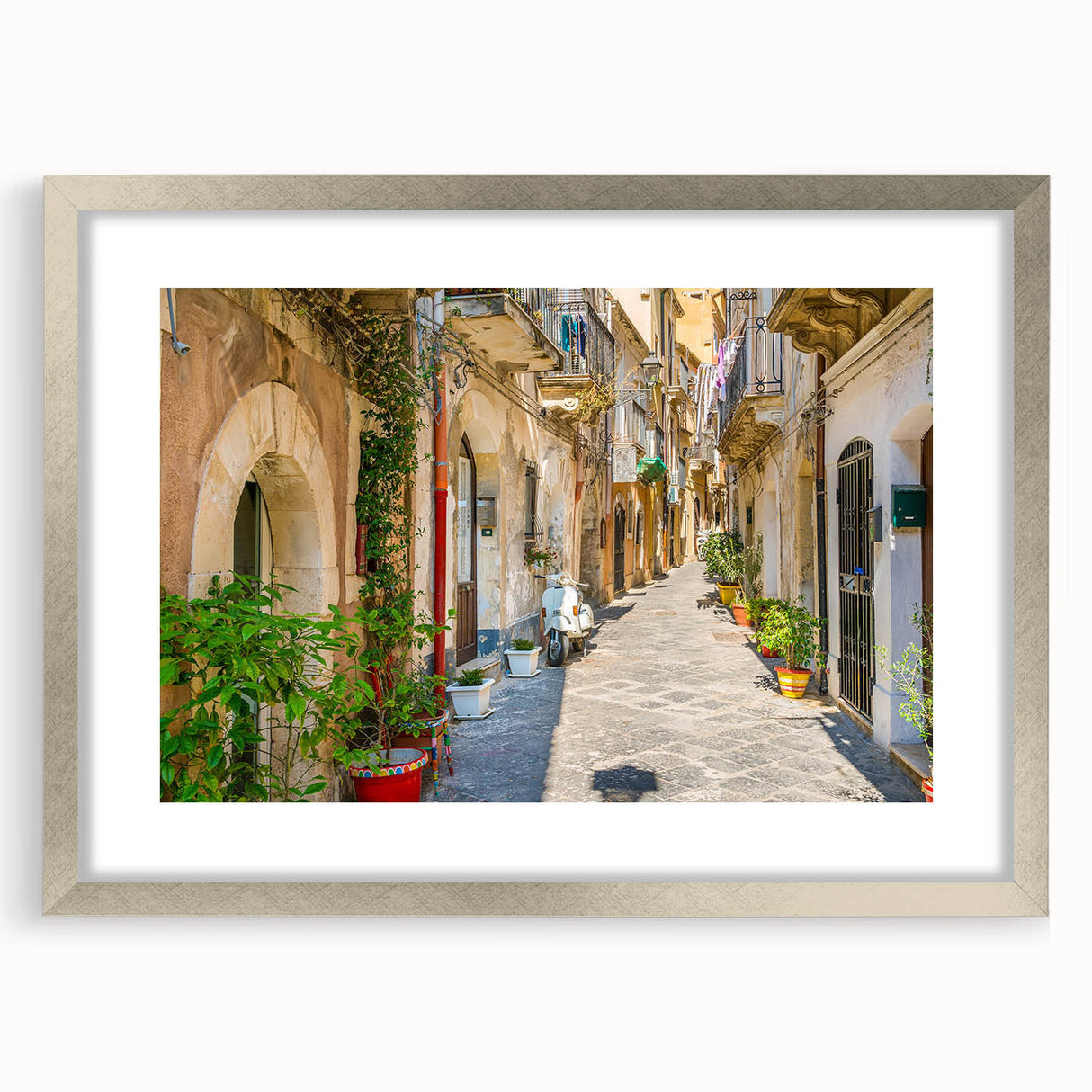 Extra large abstract art print of a Sicilian landscape in textured hues of blue and green, framed in silver.
