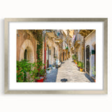 Extra large abstract art print of a Sicilian landscape in textured hues of blue and green, framed in silver.