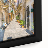 Textured black wall art of a Sicilian landscape on framed canvas, featuring colorful accents, ideal for living room decor.