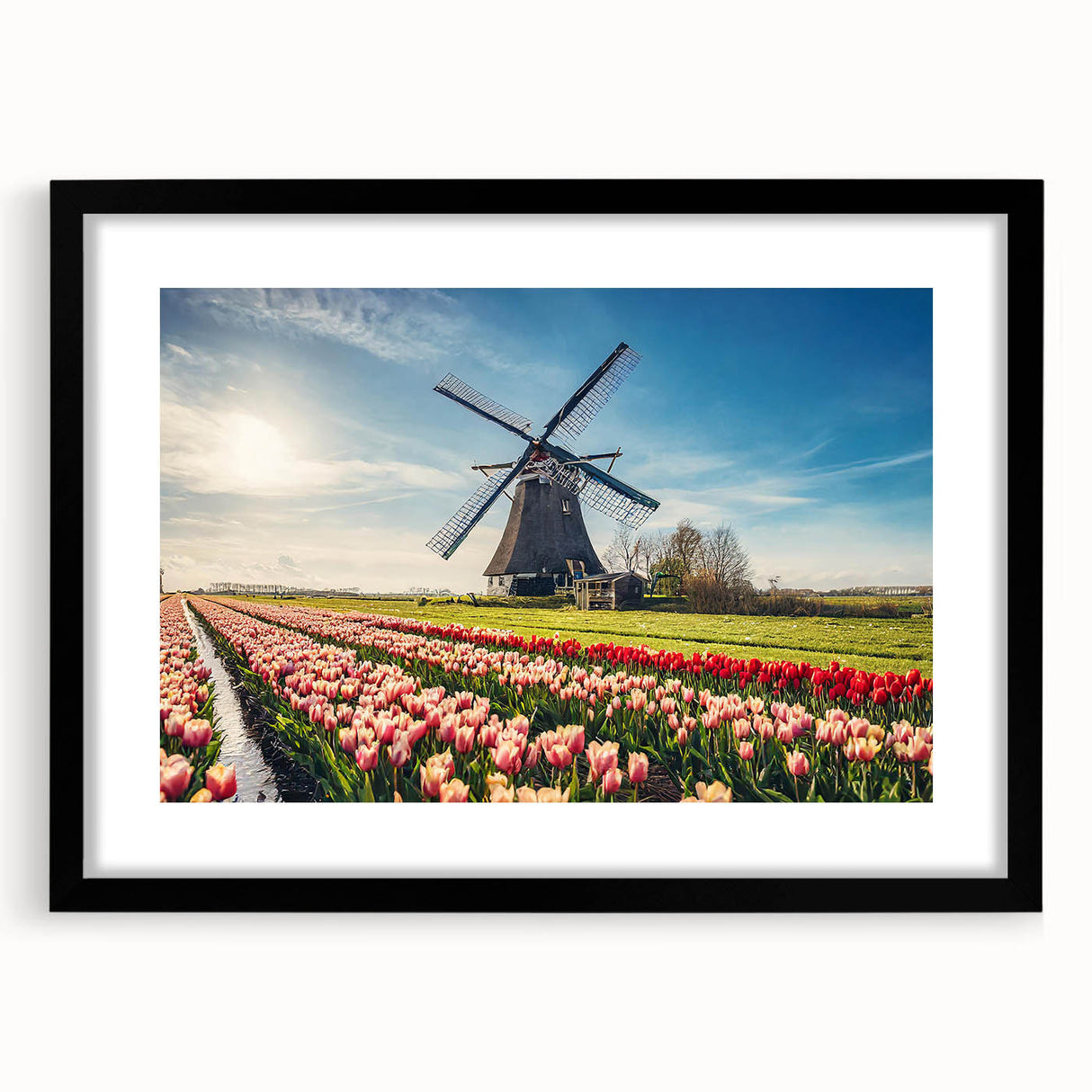 Colorful abstract art print of a European scenery in vibrant hues on a large textured canvas, framed in black.