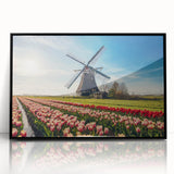 Large abstract wall art depicting a European scenery, using muted earth tones on a black framed acrylic.