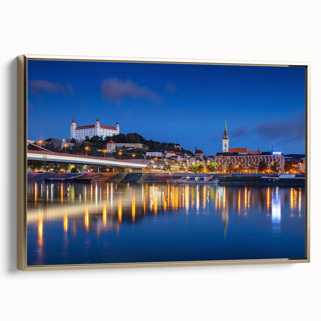 Framed canvas featuring a vintage-style landscape painting of a Slovakian scenery in muted gold and black tones.