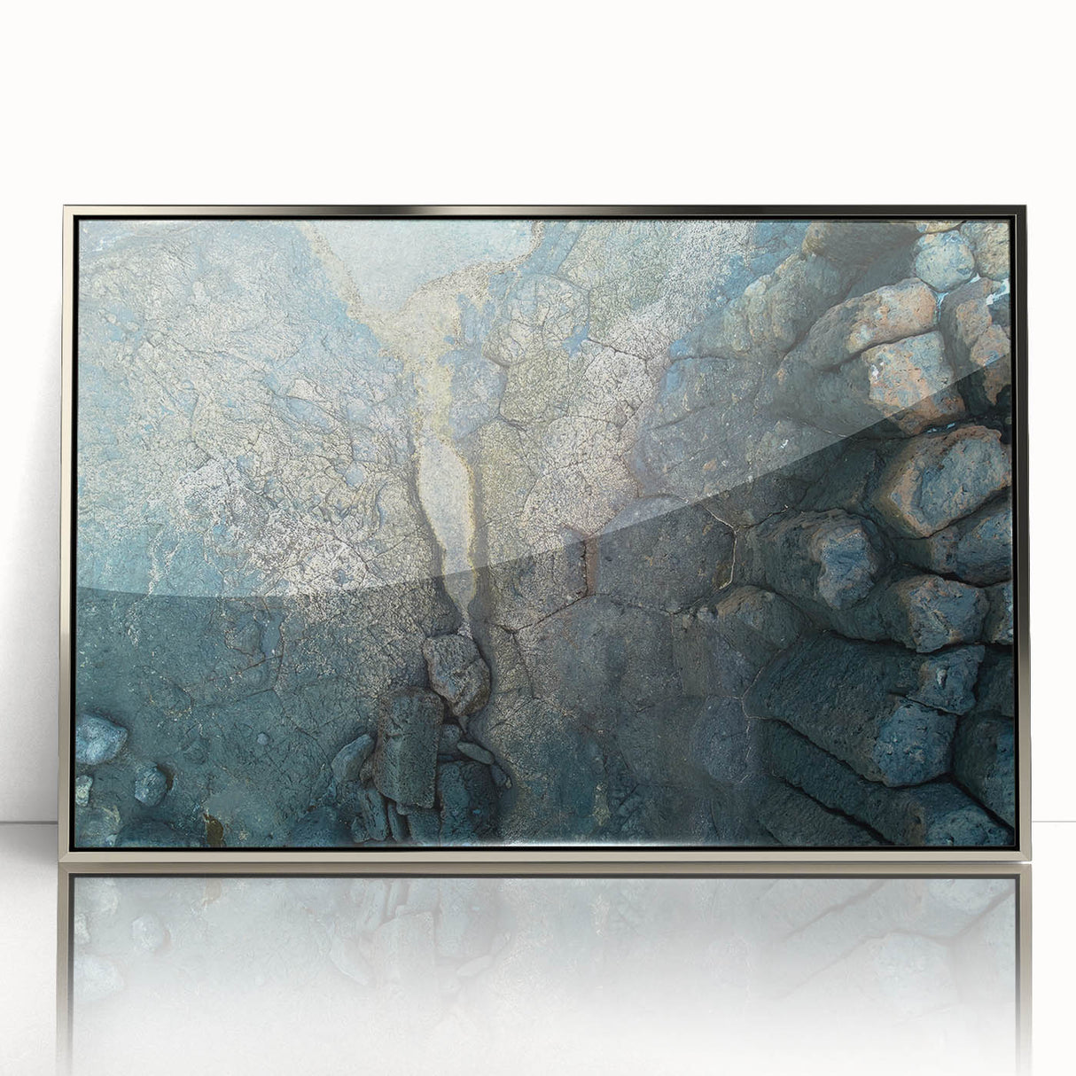 Large art print of a scenic European landscape in muted earth tones, framed in silver acrylic.
