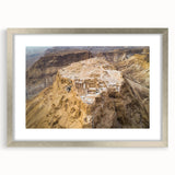 Textured art print of an abstract Middle Eastern scenery in muted earth tones, framed in silver, ideal for bedroom decor.