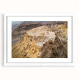 Abstract art print depicting a Middle Eastern scenery in muted earth tones on a framed white mat.