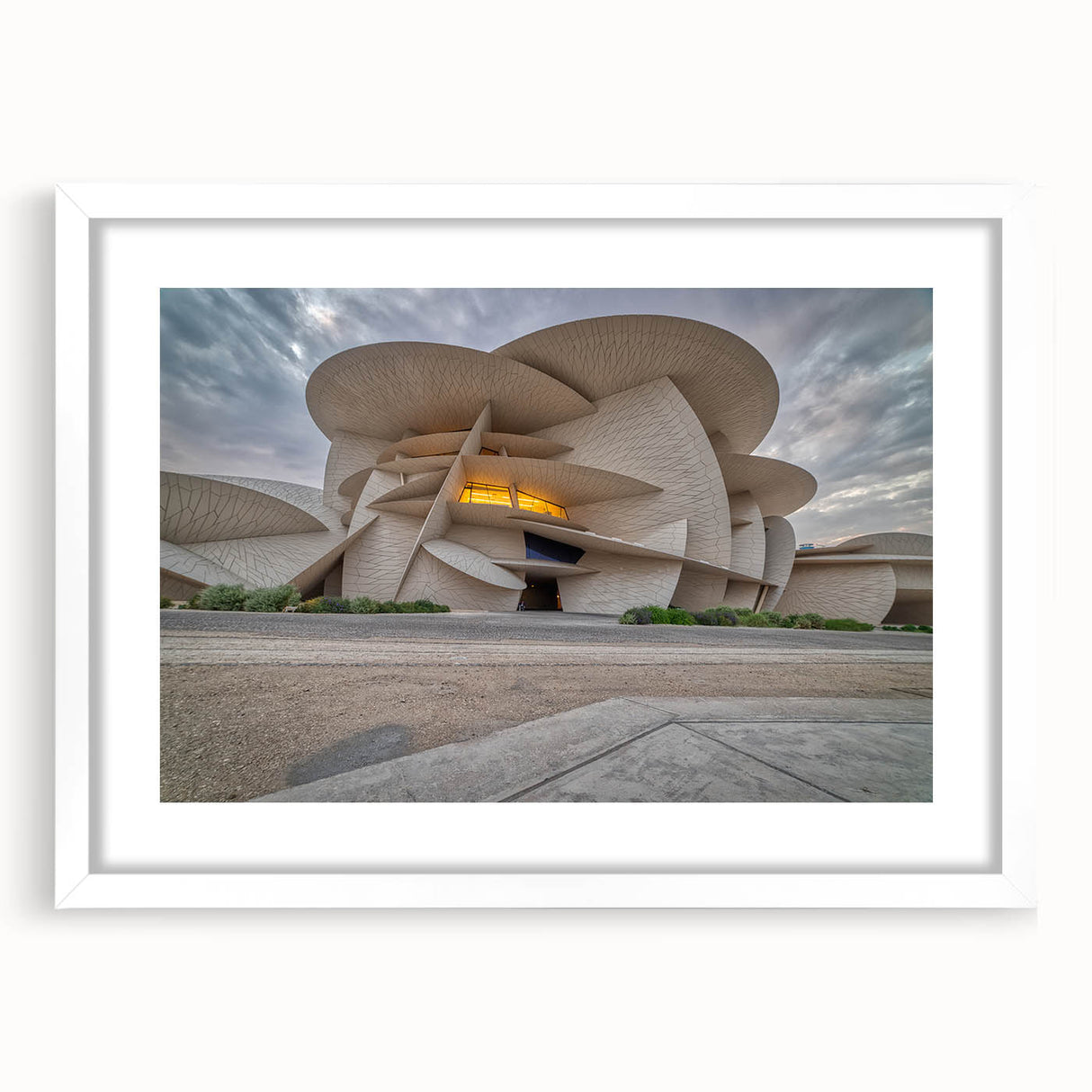Abstract art print of Qatar scenery in muted earth tones on a white matted frame, suitable for dining room decor.