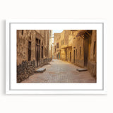 Abstract art print of a stylized Saudi Arabian landscape in muted earth tones on a framed white mat.