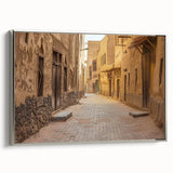Framed canvas of a vintage-style landscape painting depicting a desert scene in muted earth tones.
