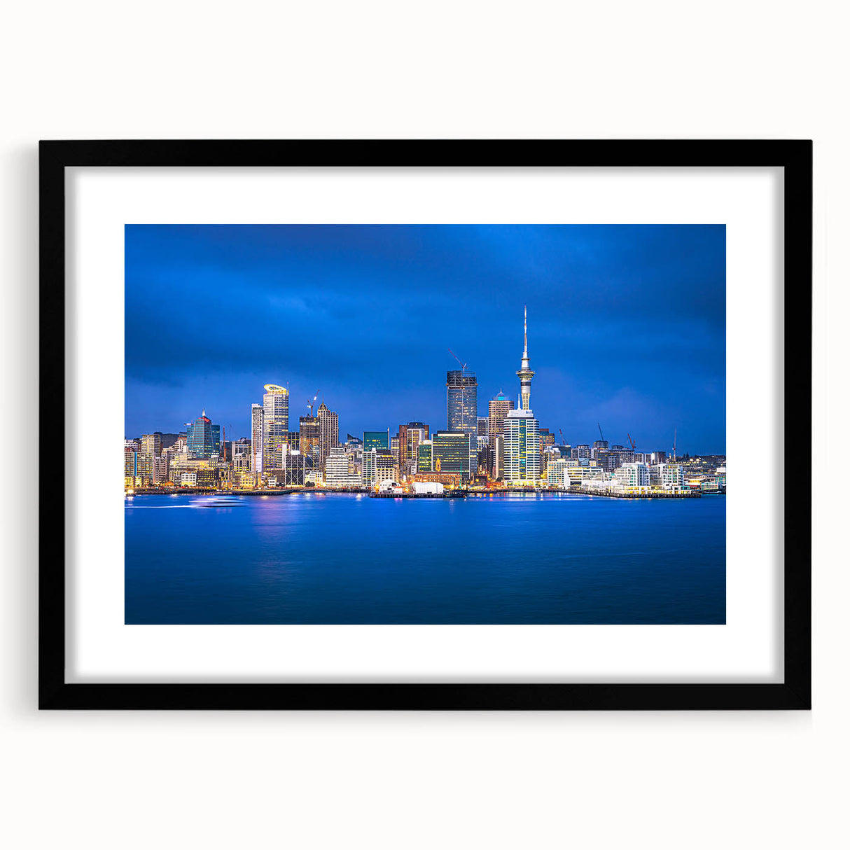 Extra large abstract art print depicting Auckland's skyline in vibrant colors on a black framed canvas.