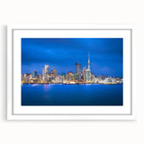Abstract art print of Auckland skyline in muted blue and gray tones on a white framed canvas, suitable for dining room decor.