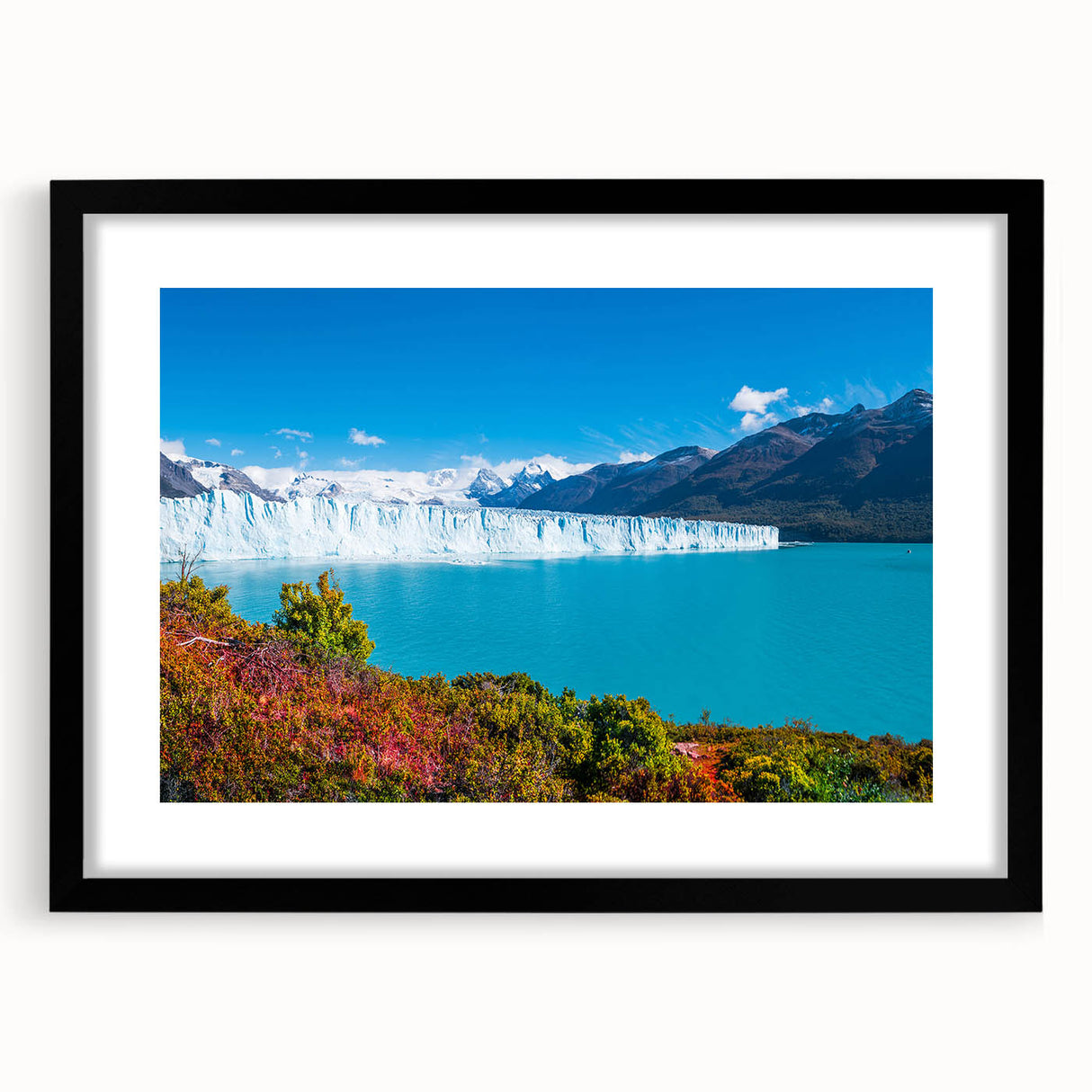 Abstract art print depicting vibrant, colorful scenery of South America on a large textured canvas, framed in black.