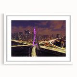 Abstract art print of a stylized Brazilian landscape in vibrant greens and blues on a white framed mat.