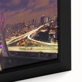 Close-up of textured black wall art depicting a colorful Brazilian landscape on framed canvas.