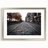 Textured art print of Savannah scenery in muted earth tones on a framed silver mat, suitable for bedroom decor.