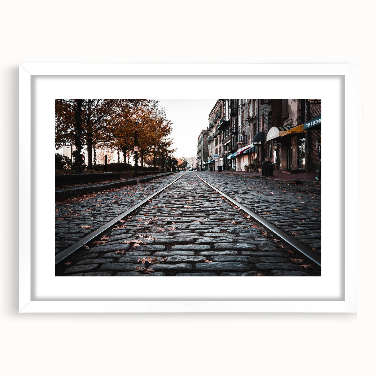 Abstract art print of Savannah scenery in muted green and blue tones on a white framed mat, ideal for dining room decor.