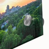 Large abstract wall art of Raleigh skyline in muted blue and green tones on acrylic glass, ideal for dining room decor.