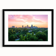 Colorful abstract art print of Raleigh skyline in vibrant hues on a large framed canvas, suitable for living room decor.