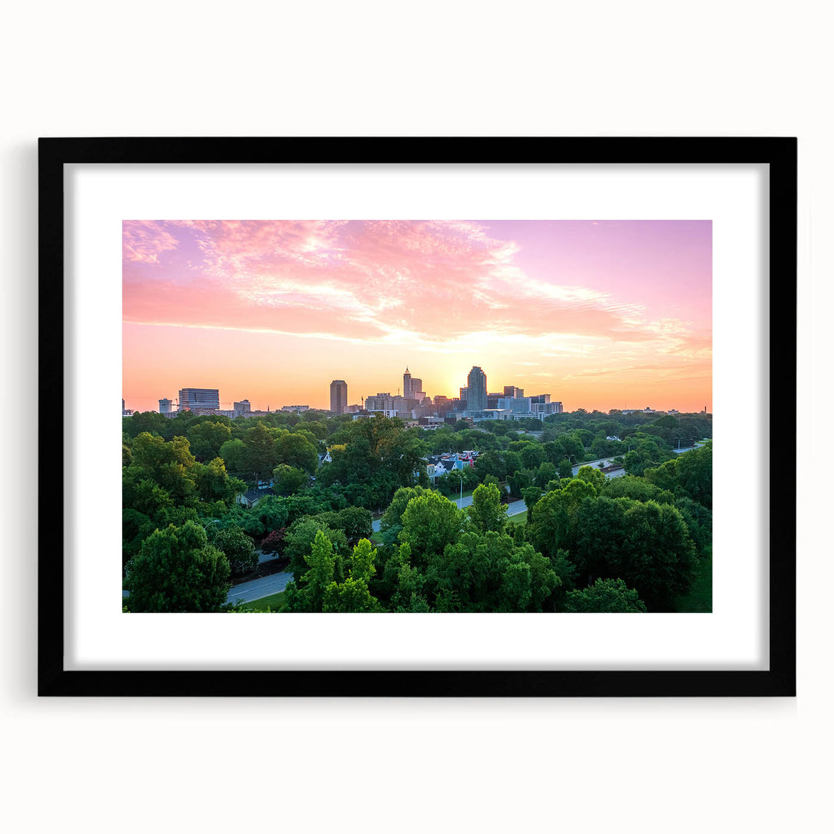 Colorful abstract art print of Raleigh skyline in vibrant hues on a large framed canvas, suitable for living room decor.