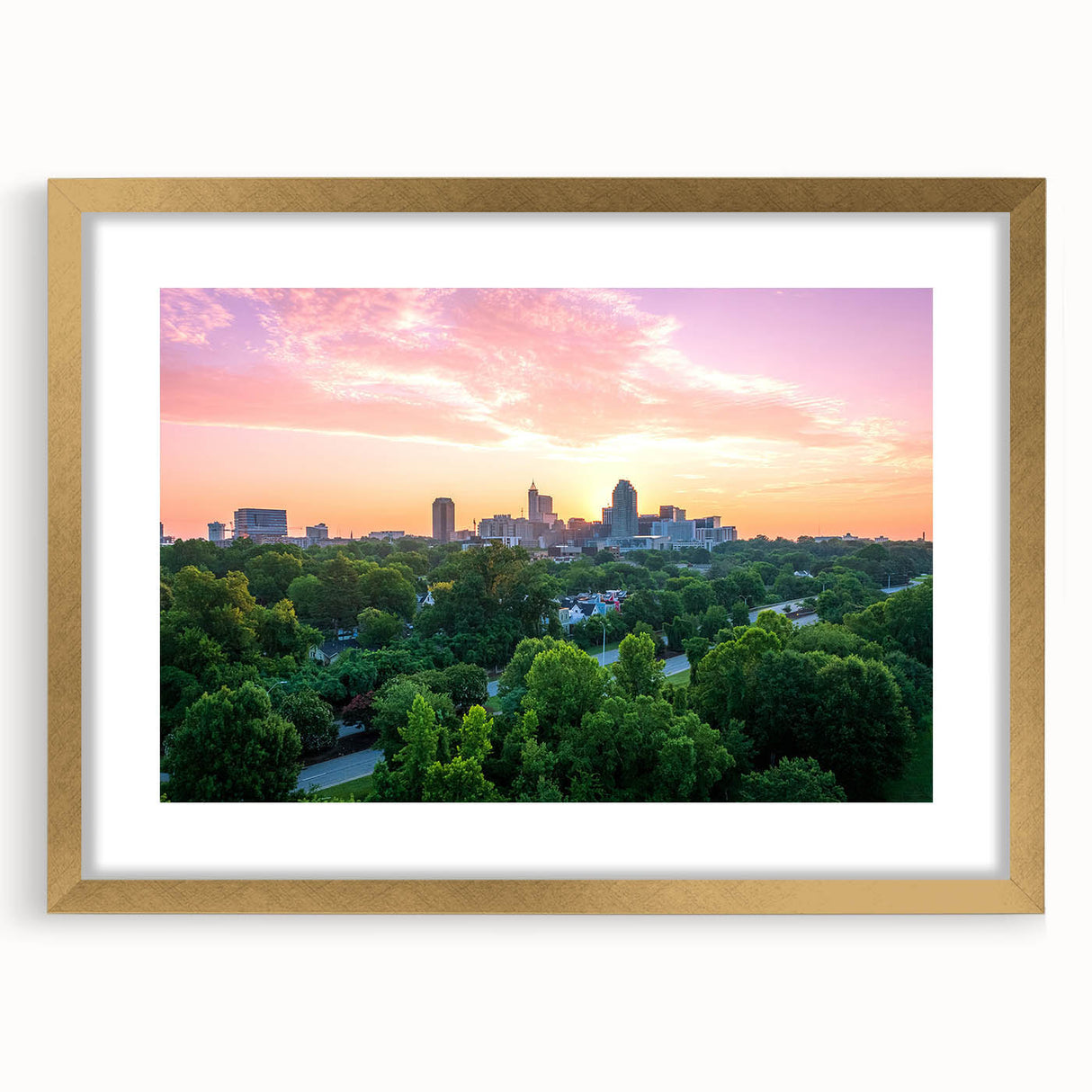 Extra large abstract art print of Raleigh, featuring textured swirls in gold and black, framed with a gold mat.