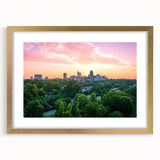 Extra large abstract art print of Raleigh, featuring textured swirls in gold and black, framed with a gold mat.