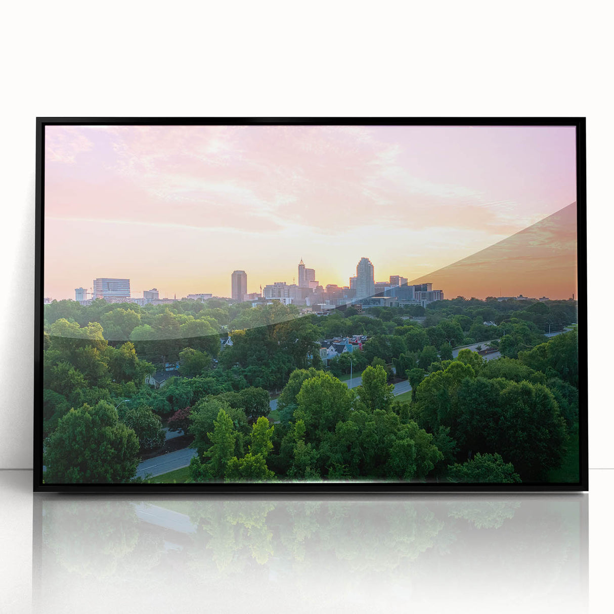 Large abstract wall art of Raleigh's skyline in muted gray, acrylic print framed in black, suited for modern decor.