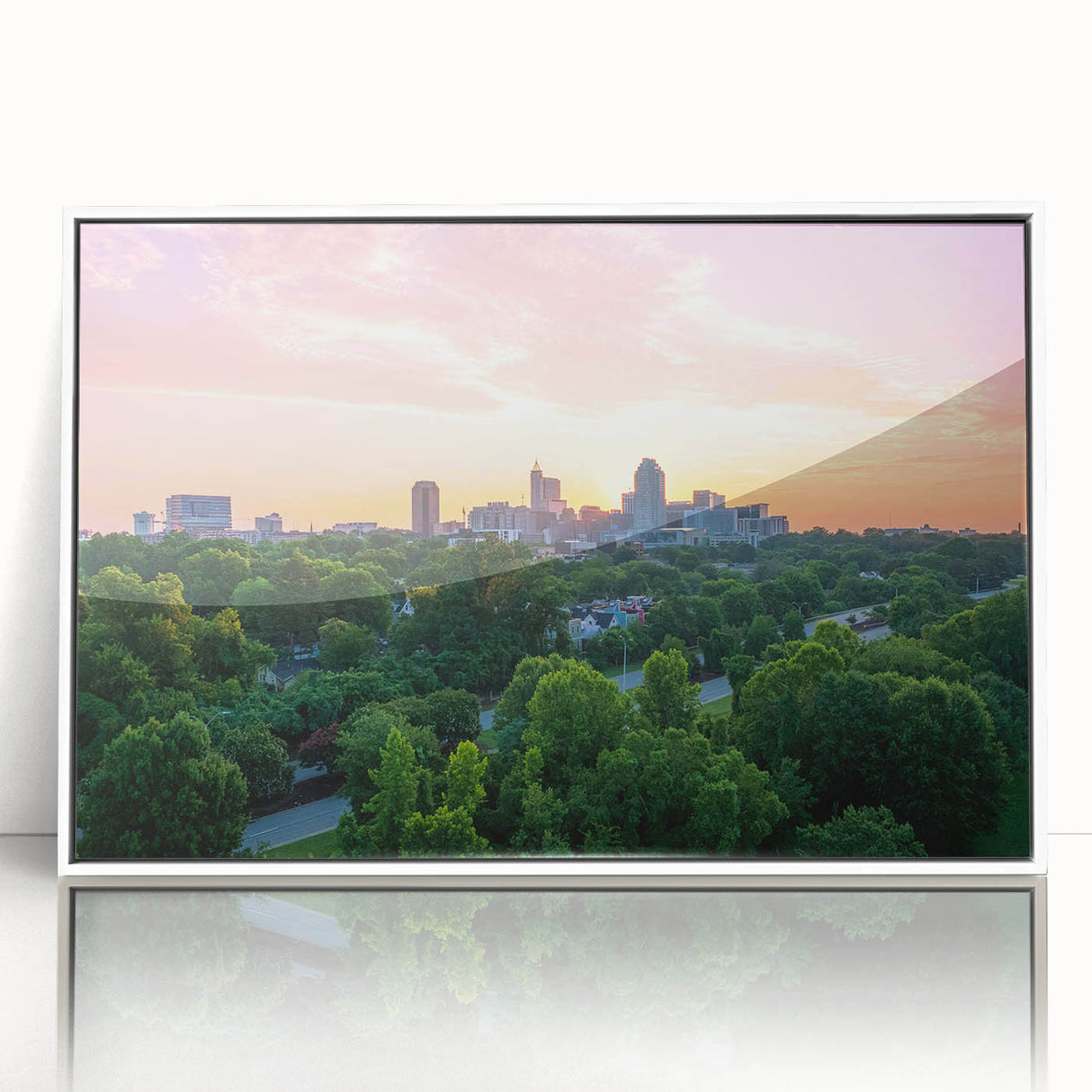 Art deco poster of Raleigh, North Carolina skyline in muted gray and blue tones on a white framed acrylic.