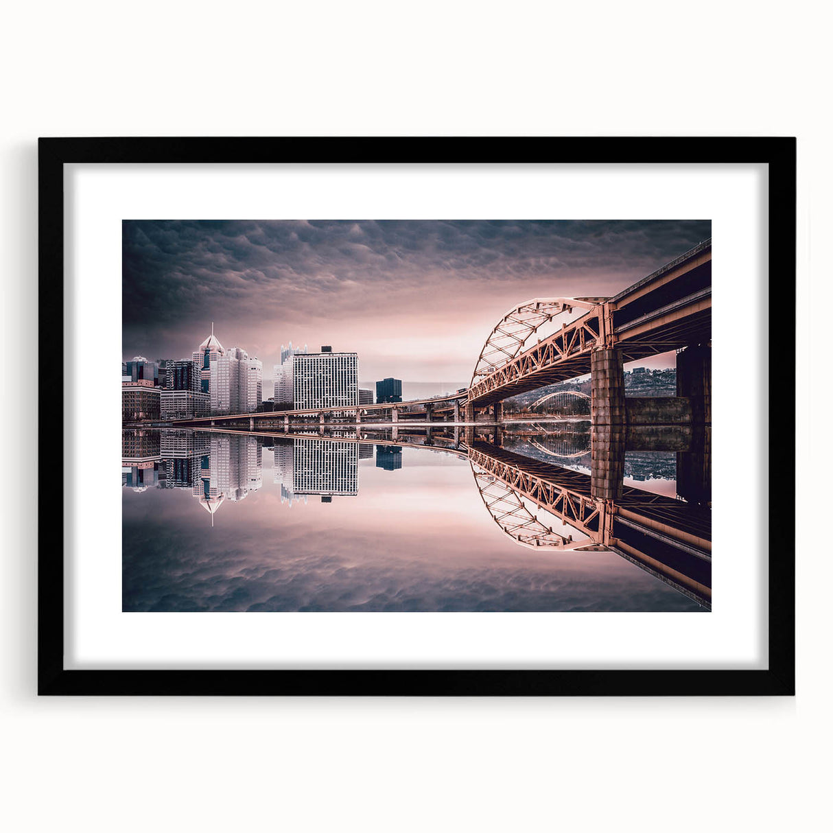 Abstract art print of Pittsburgh skyline in vibrant colors on a large black framed canvas, ideal for living room decor.